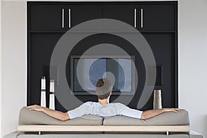 Rear View Of Man Watching Television photo