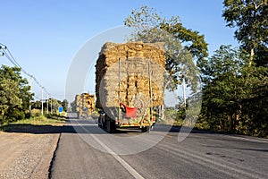 A rear view of the many bales of straw, harvested from the rice fields and packed on a truck