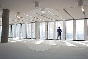 Rear view of mature businessman visiting empty office space