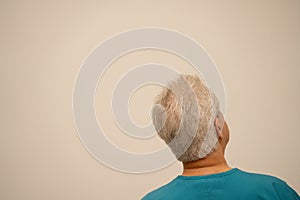 Rear view of a medical doctor or nurse glancing at a white wall