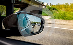 Rear view mirror of a car with multiple vehichles in the jam