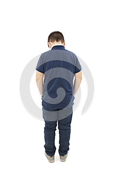 Rear view of modern little boy, standing with hands in pockets