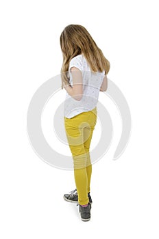 Rear view of modern little girl, standing. Isolated on white background. Back view