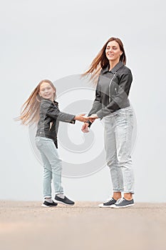 Rear view. mother and daughter holding each other`s hands