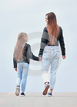 rear view. mother and daughter step forward