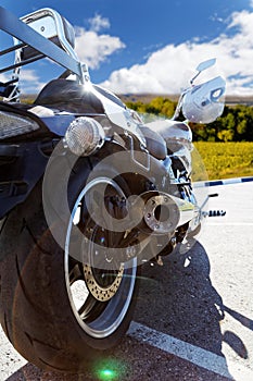 Rear view on motorcicle against blue sky photo