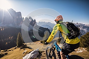 Rear view of a mountain biker cycling on top of a mountain