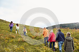 Rear View Of Multi-Generation Family Walking In Countryside With Fishing Nets On Winter Vacation