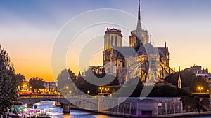 Rear view of Notre Dame De Paris cathedral day to night timelapse after sunset.