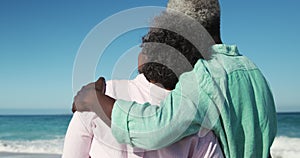 Rear view old couple looking at the beach