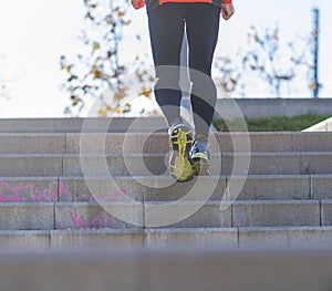 Rear view of one senior caucasian athlete man training running up and down the stairs outdoors in a park in a sunny day