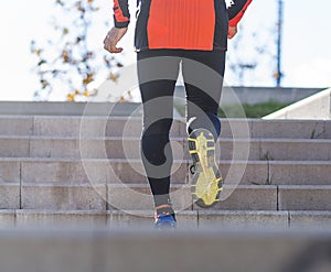 Rear view of one senior caucasian athlete man training running up and down the stairs outdoors in a park in a sunny day