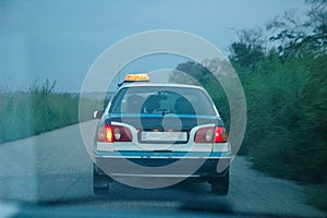 Rear view of one taxi on the street in Congo at dusk