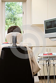 Rear view of person in dentist chair