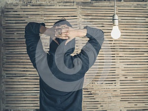 Rear view of person by light bulb