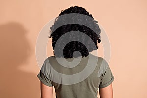 Rear view photo of adorable person with perming coiffure dressed khaki t-shirt demonstrate hairdo isolated on pastel photo