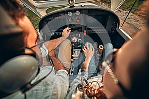 Rear view of pilot and copilot operating controls of private plane