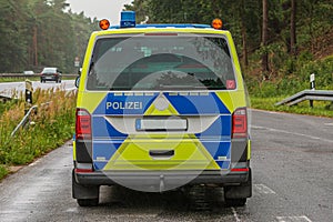 Rear view of a police car from the state of Brandenburg in the rain