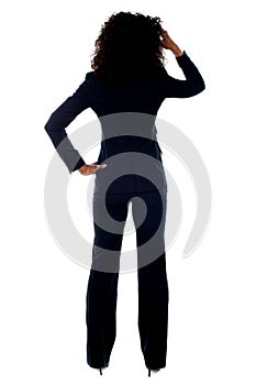 Rear view portrait of confused businesswoman