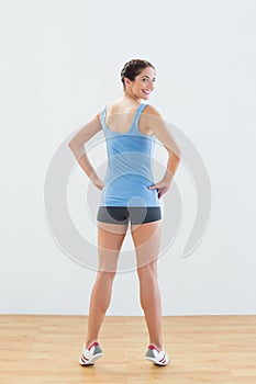 Rear view portrait of a smiling woman tip toeing