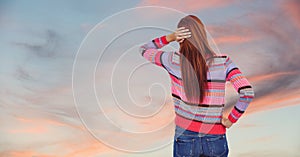 Rear view of redhead woman against sky