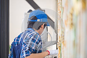 Rear view of repairman fixing air conditioning system, Technicians check air conditioning system refrigerant recharge, Air