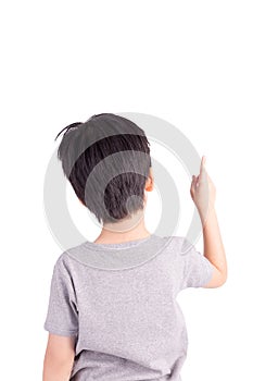 Rear view of a school boy over white background pointing upwards
