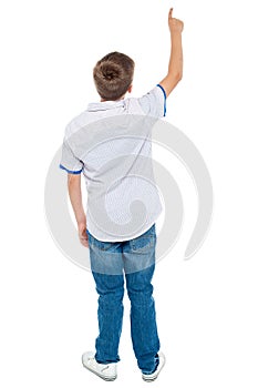 Rear view of a school boy pointing upwards