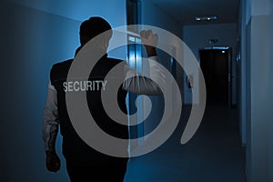 Security Guard Standing In Corridor Of The Building photo