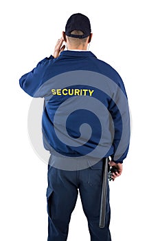 Rear view of security officer listening to earpiece