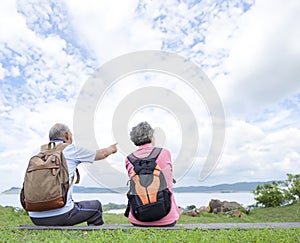 Rear view Senior couple hiking on the mountain