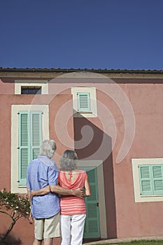 Rear View Of Senior Couple Looking At House