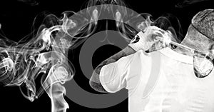 Rear view of senior male golf player swinging gold club against smoke effect on black background