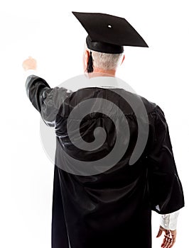 Rear view of a senior male graduate pretending to work on virtual screen