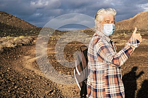 Rear view of senior man walking in a stepped path enjoying nature and first leaving home after lockdown for coronavirus. Arid