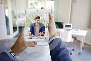 Rear view shot of businessman having online meeting in video call