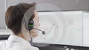 Rear view shot of a female call center agent wearing headset while working