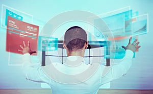 A rear view shot of a man using a futuristic computer. All screen content is designed by us and not copyrighted by
