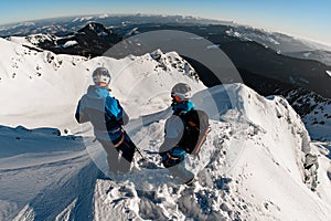 rear view of skiers on snow-capped mountain against the backdrop of a beautiful landscape