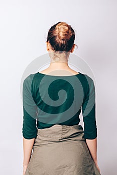 Rear view slender girl with bun hairstyle