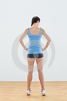 Rear view of a slim woman tip toeing