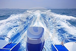 Rear view of speed boat running high speed on blue sea water use