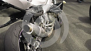 Rear view of a sport motorcycle parked on the side of a road