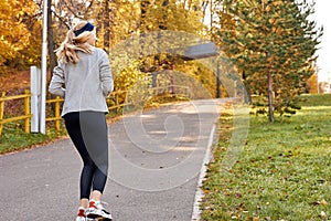 Rear view on sportive woman running in the park