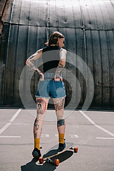 rear view of stylish tattooed girl