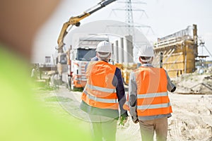 Rear view of supervisors walking at construction site