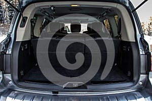 Rear view of a SUV car with open trunk