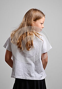 Rear view of the teenage girl concealing something photo