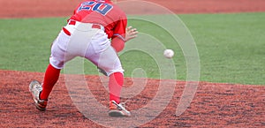 Third baseman fielding the ball during a baseball game photo