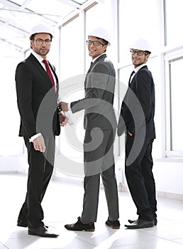 Rear view.three architects standing in the corridor of the new building